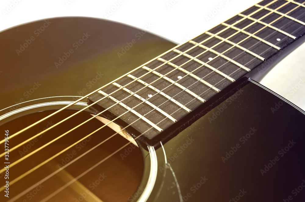 part of an acoustic guitar on white. Close-up. Image is tinted.