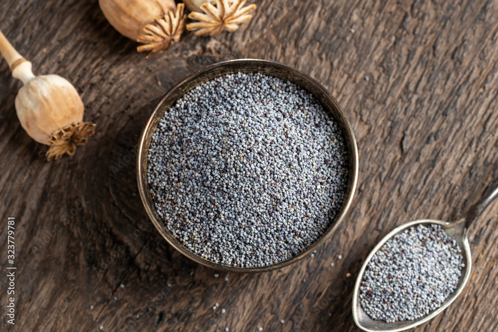 Poppy seeds and capsules on a table Poppy seeds and capsules on a table
