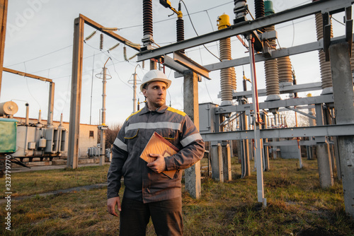 Wallpaper Mural The energy engineer inspects the equipment of the substation. Power engineering. Industry Torontodigital.ca