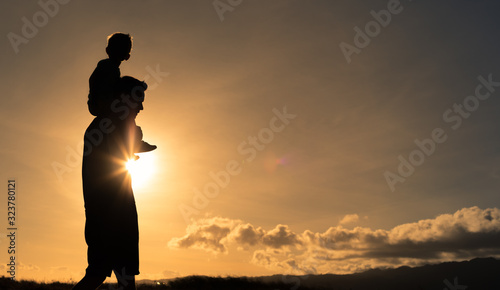Quadro su tela Father walking with his child giving him a piggyback ride