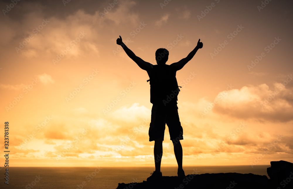 Strong male mountain climber with thumbs up celebrating success and life 