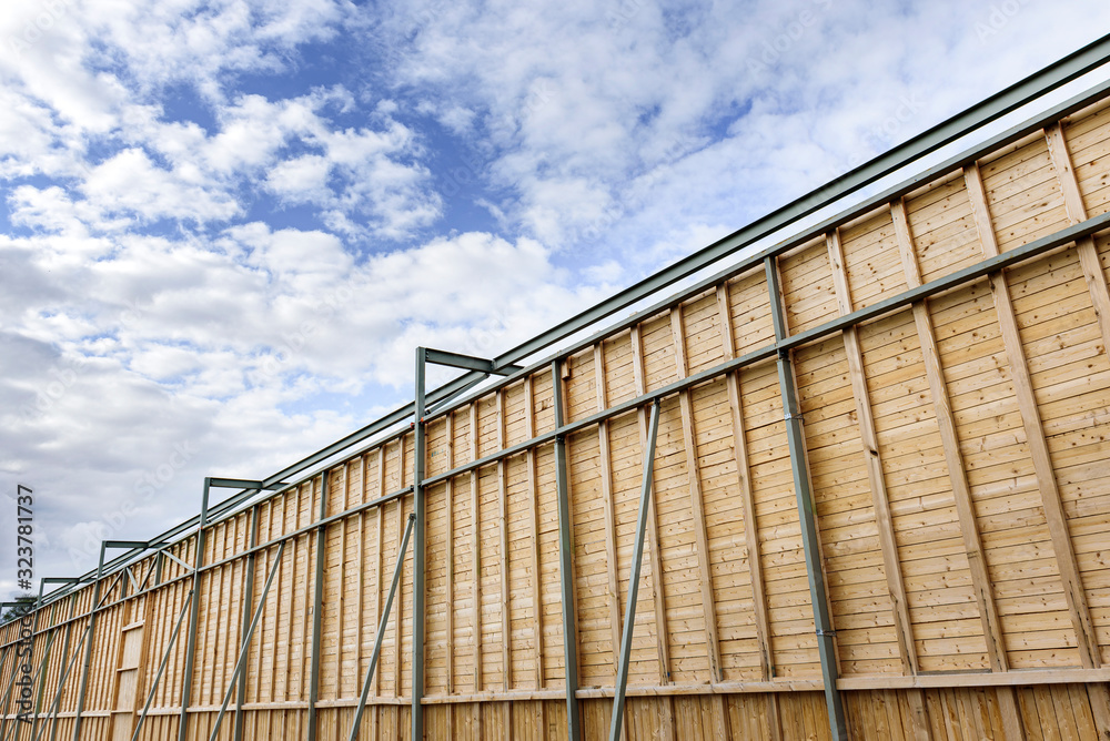 Tall wooden wall in outdoors with metal parts. Tall wooden wall in outdoors with metal parts.