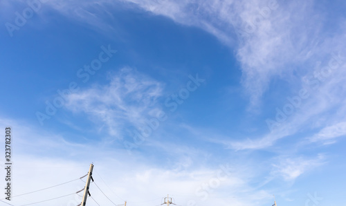 Blue sky with clouds, Sky background image, Electric pole at bottom of picture.