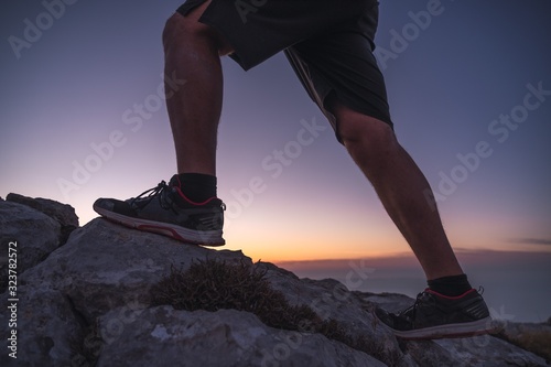 Legs of a man in summer sportswear walking in the rocks © Daniel