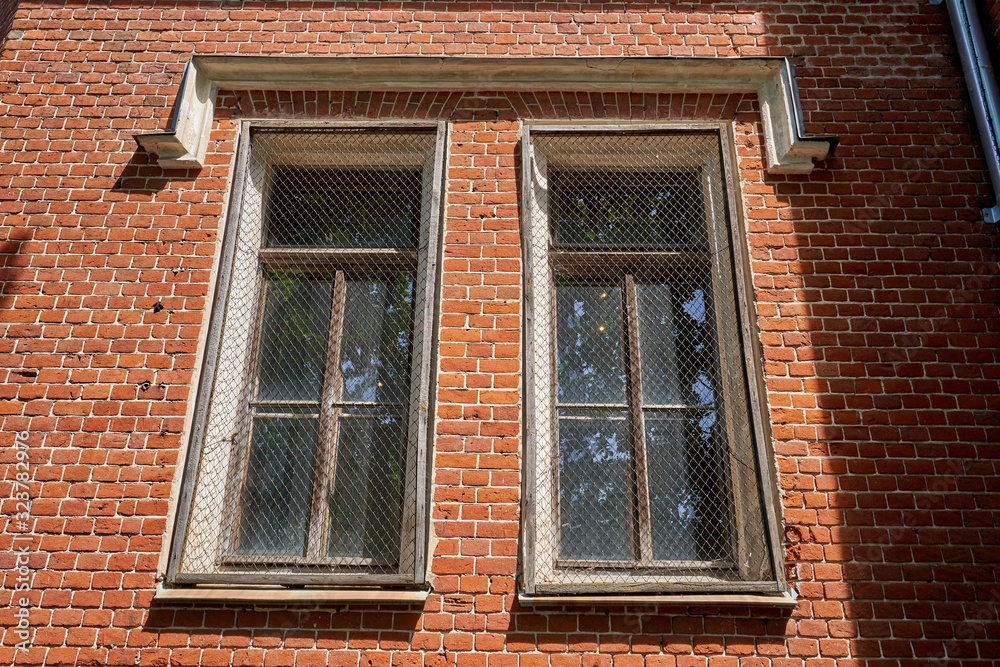The windows of the old palace with a metal mesh for security