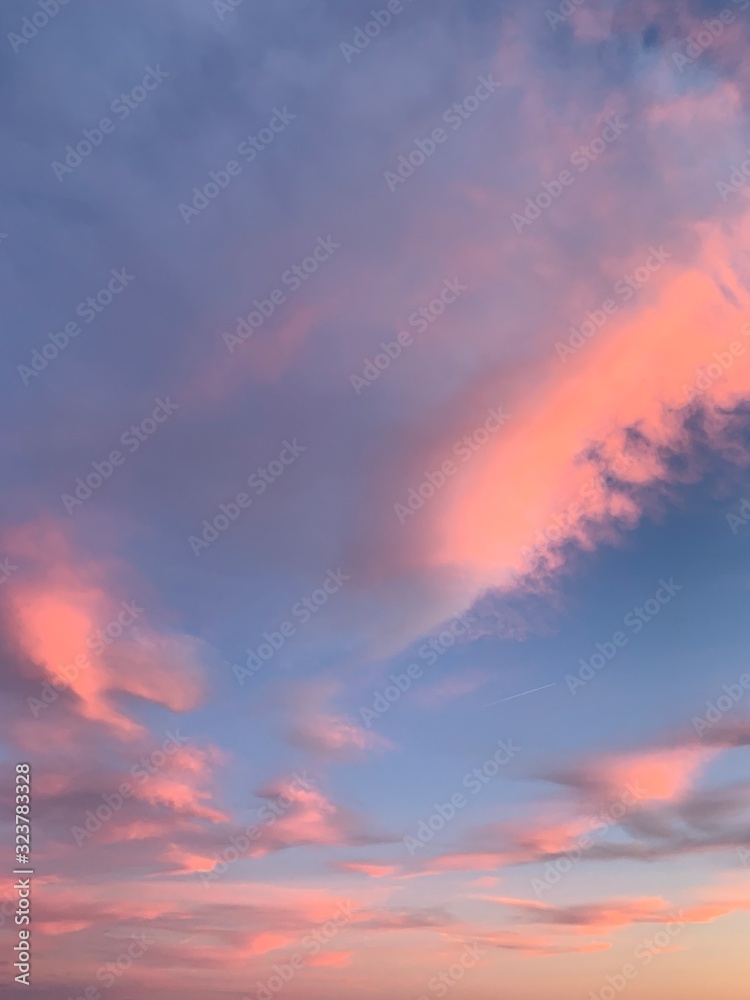 Tender pink clouds in the blue sky, natural colors