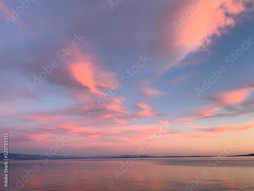Tender pink clouds in the blue sky, natural colors © Oksana