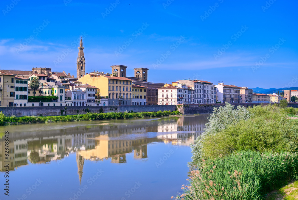 A daytime view along the Arno River in Florence, Italy.