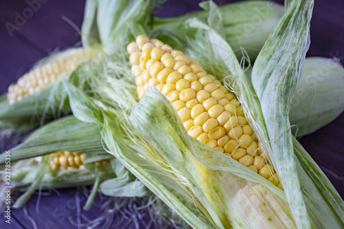 Grains of ripe corn. macro. Corn on the cob, the food is ripe, juicy, delicious corn. Photo of corn background. Fresh young sweet corn on cobs, closeup. Fresh corn on rustic wooden background.