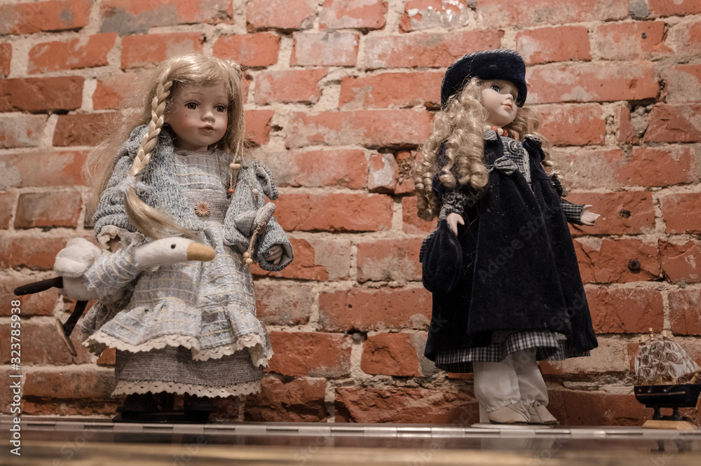 Two porcelain dolls in beautiful dresses