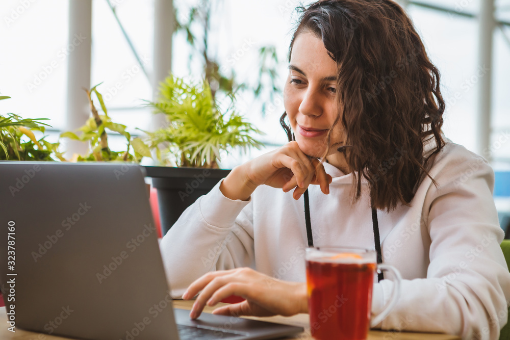 young gorgeous woman working on laptop in cafe young gorgeous woman working on laptop in cafe