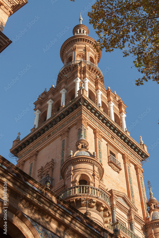 Fototapeta premium Details of the architecture and decoration in the Plaza de España in Seville with warm orange light at sunset.