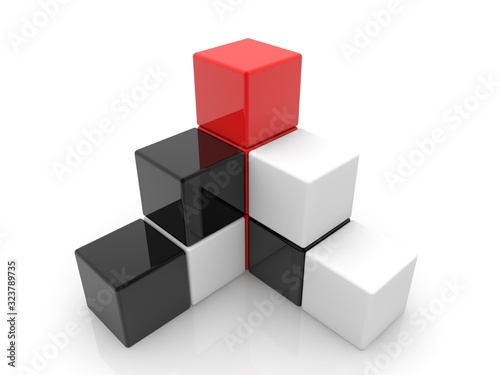 Abstract black and white pyramid of toy blocks with a red block at the top