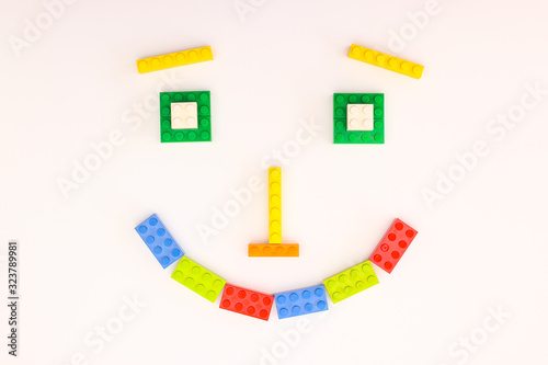 Smiley face made of colorful plastic bricks for kids