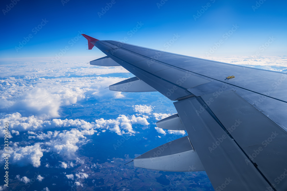 Fototapeta premium Aerial view from the plane over fluffy clouds