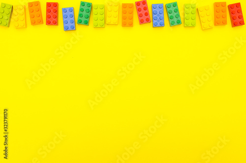 Plastic bricks for kids in different colors on the table
