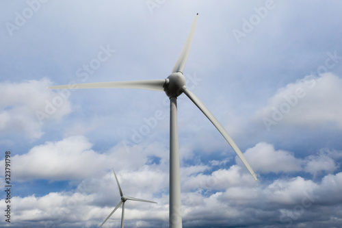 two wind wheels in front a cloudscape © Tobias Arhelger