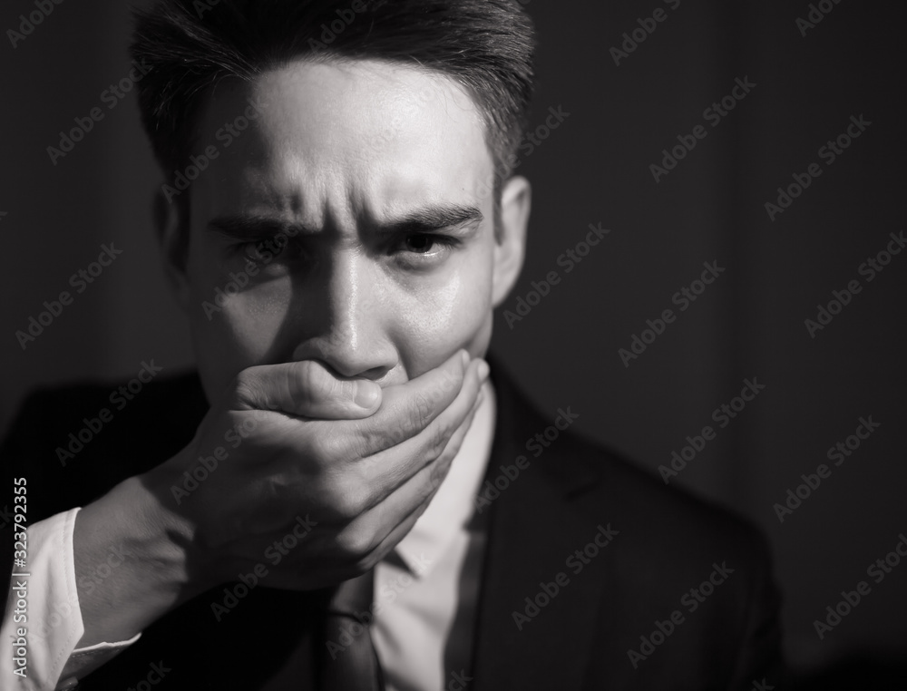 Man with hand over mouth keeping himself from talking. Top secret, silenced concept. Man with hand over mouth keeping himself from talking. Top secret, silenced concept.