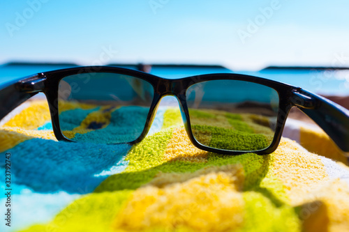 Beach holiday concept. Sunglasses on the beach.