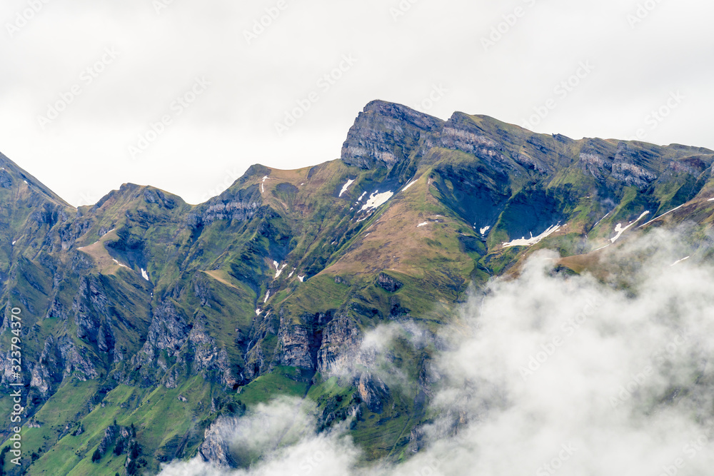 The Swiss Alps at Murren, Switzerland. Jungfrau Region. Tops of the mountains in fog and clouds. The Swiss Alps at Murren, Switzerland. Jungfrau Region. Tops of the mountains in fog and clouds.