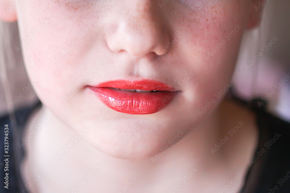 Young attractive teenager girl's face view with lipstick on lips Young attractive teenager girl's face view with lipstick on lips