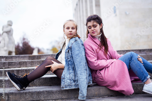young happy students teenagers at university building on stairs, lifestyle people concept brunette and blond girl © iordani