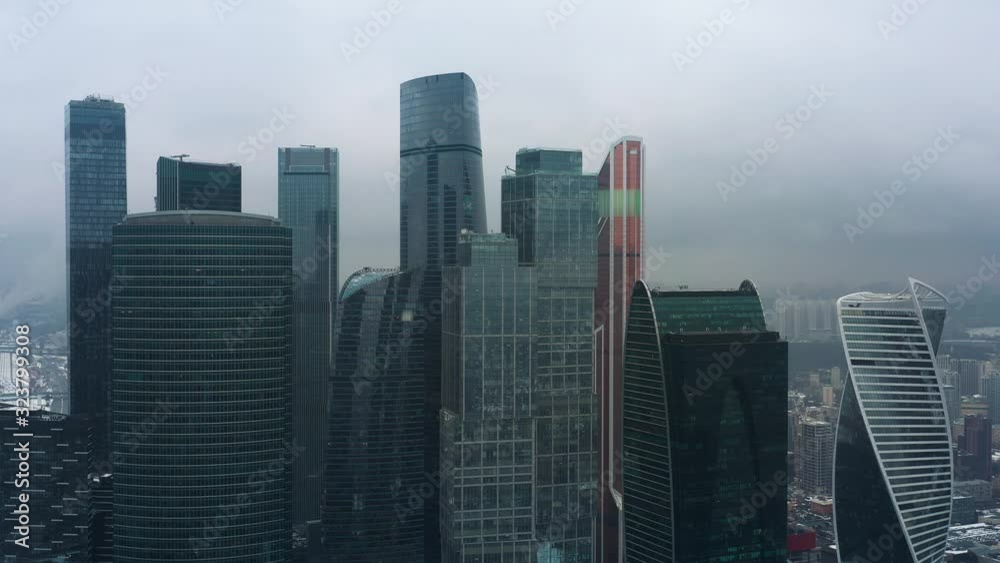Aerial drone shot flying over center of Moscow city buildings, skyscrapers at cloudy winter day. Drone shot flying over Moscow skyscrapers. Aerial drone shot flying over center of Moscow city buildings, skyscrapers at cloudy winter day. Drone shot flying over Moscow skyscrapers.