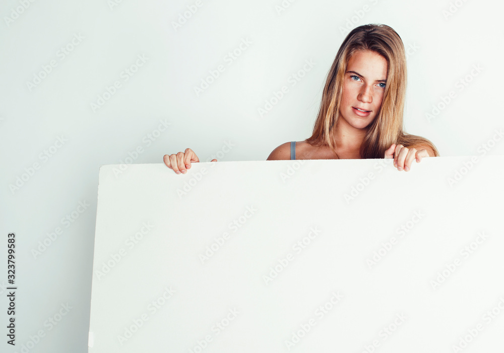 young pretty blonde girl with placard on white background half naked, shopping sale lifestyle people concept young pretty blonde girl with placard on white background half naked, shopping sale lifestyle people concept