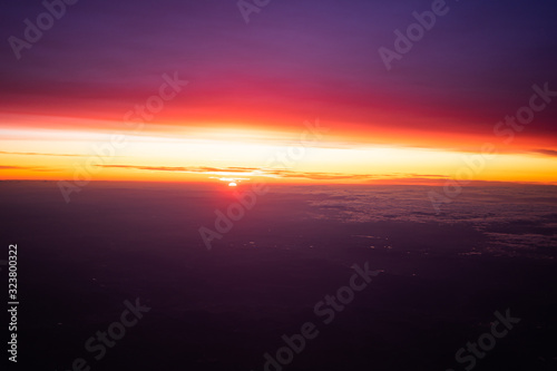 sunrise in the sky over the clouds