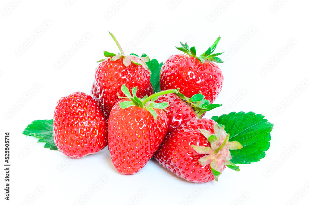 Heap of strawberries with half cut and leaves isolated on a white Heap of strawberries with half cut and leaves isolated on a white