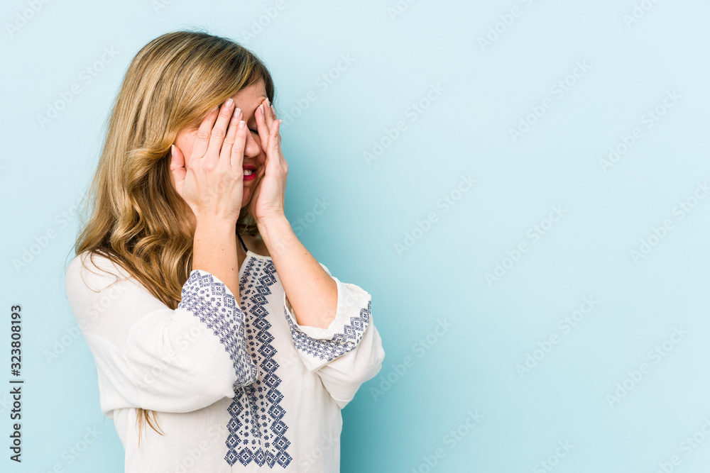 Young blonde caucasian woman afraid covering eyes with hands. Young blonde caucasian woman afraid covering eyes with hands.