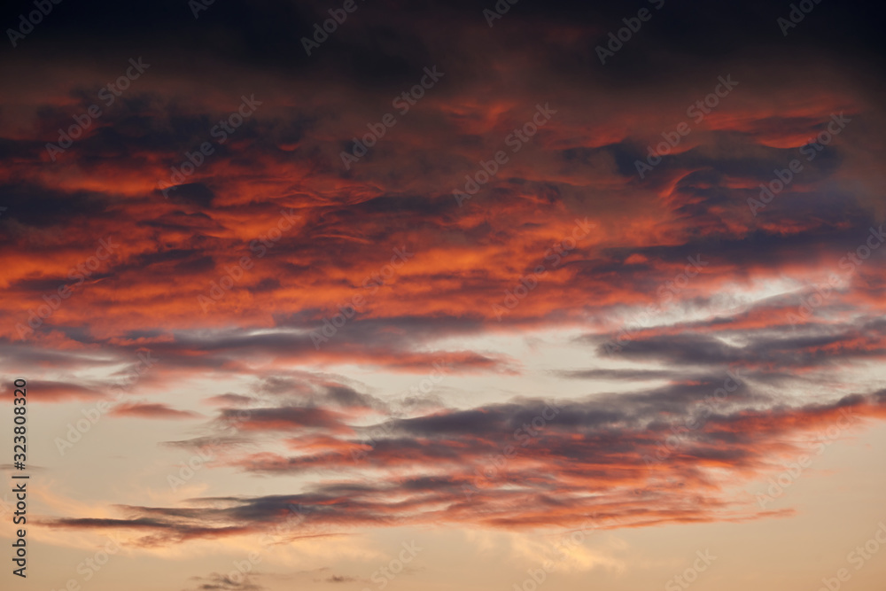 beautiful dramatic sky with dark and bright clouds at sunset, summer landscape, golden sunlight