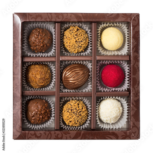 Box of chocolates isolated on a white background, truffle and coconut candies, assorted sweets with different fillings
