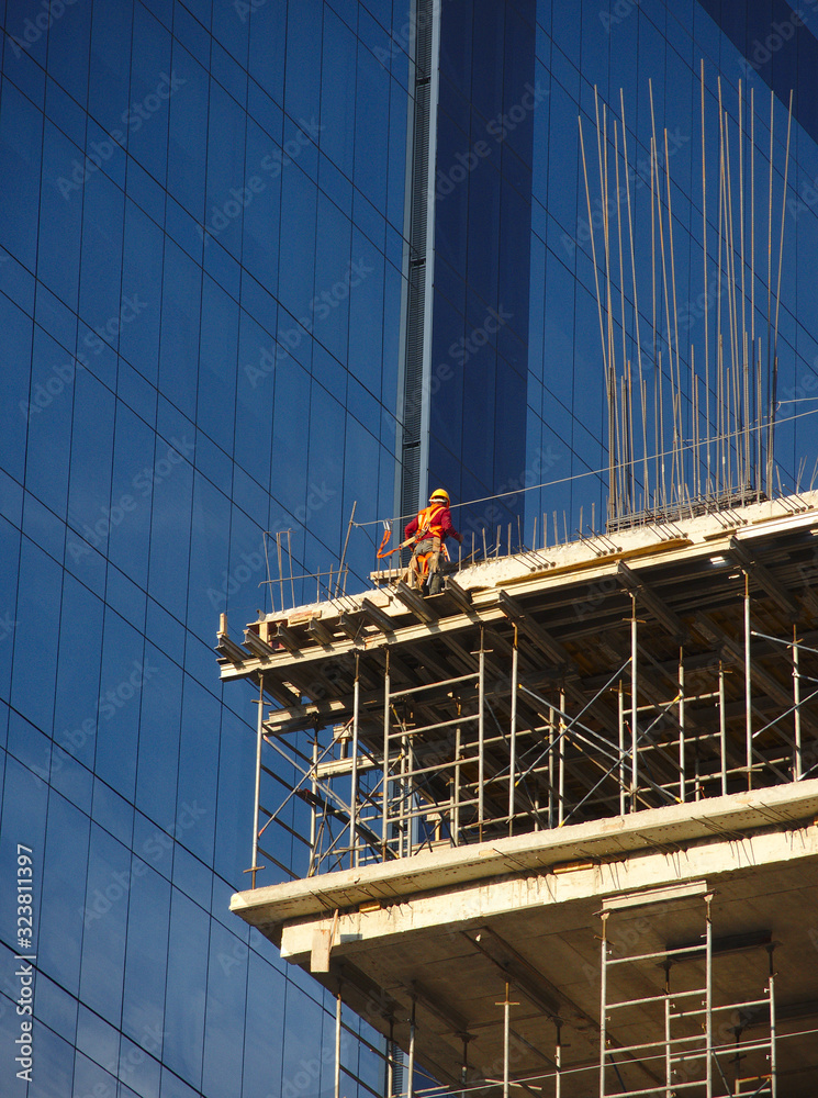 Worker in high skycraper, safety concept
