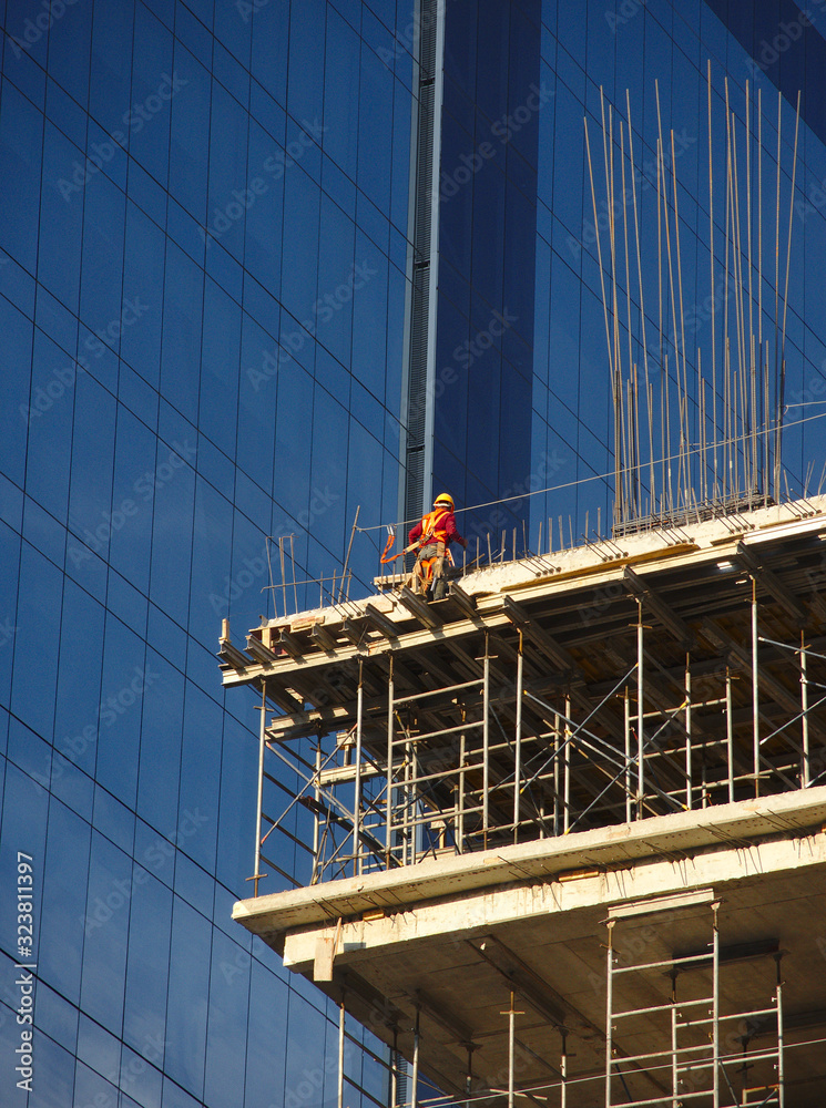 Worker in high skycraper, safety concept Worker in high skycraper, safety concept