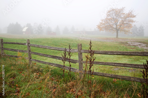 Farm barn in foggy morning