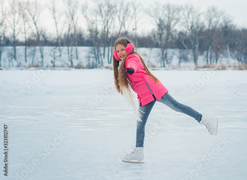 The girl on ice skating in pink wear.
