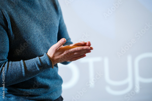 guy businessman at the conference tells information to people