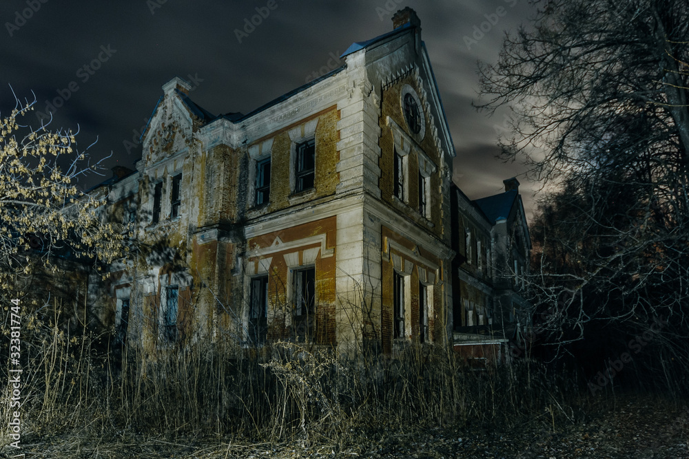 Dark and creepy old abandoned haunted mansion at night. Former Karl von