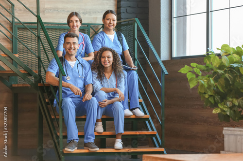 Group of medical students on stairs in modern clinic