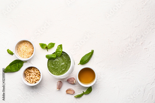 Pesto sauce with ingredients on white background