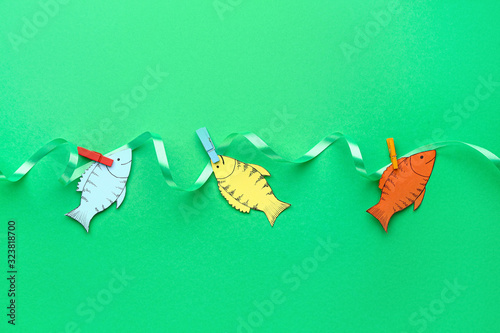 Paper fishes on color backg...