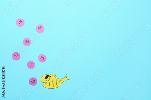 Paper fish on color backgro...
