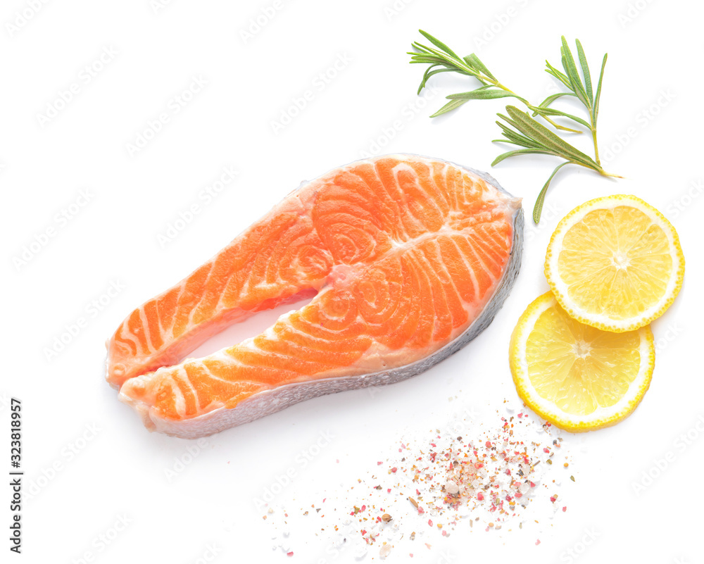 Raw salmon steak and spices on white background