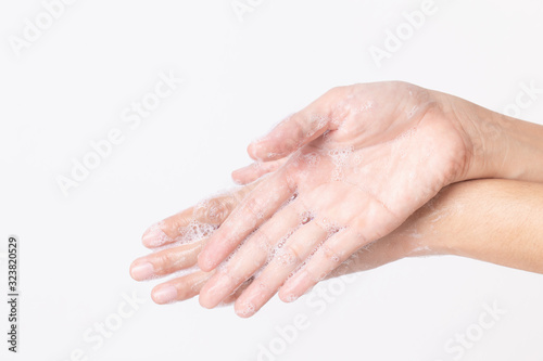 Asian girl hands are washing with soap bubbles on white background.
