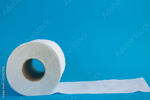 Toilet paper on blue bathroom background