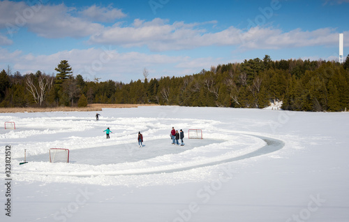 People skating outdoors on a frozen pond