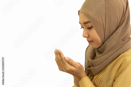 young muslim woman praying dua for allah isolated on white background with clipping path photo