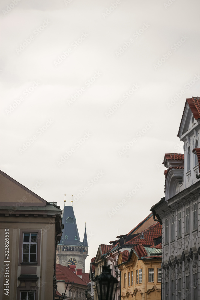 Old Town Hall tower, a clock tower, in Prague, Czech Republic, surrounded by the facades of the narrow streets of Old Town. Also called Staromestska radnice, it is a major landmark of the city