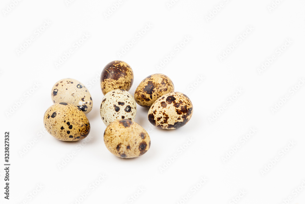 Uncooked scattered Quail eggs on white background top view, healthy food concept Uncooked scattered Quail eggs on white background top view, healthy food concept